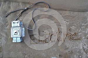 ÃÂÃÂ¡ool bag in the form of a robot on the sand.